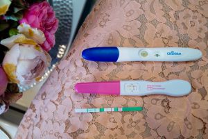 pregnancy announcement, pregnant, pregnancy test, positive test, flowers and lace, having a baby